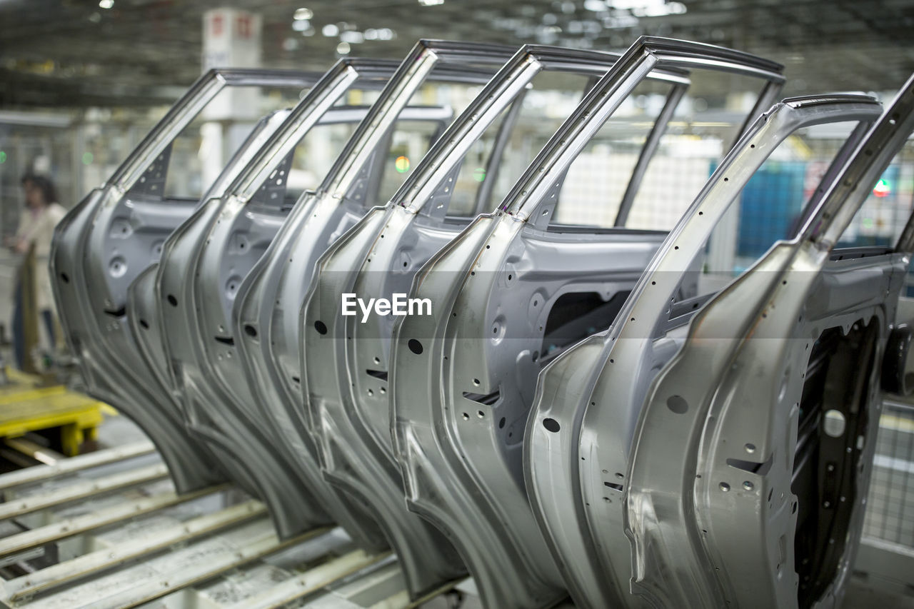 Modern automatized car production in a factory, row of car doors