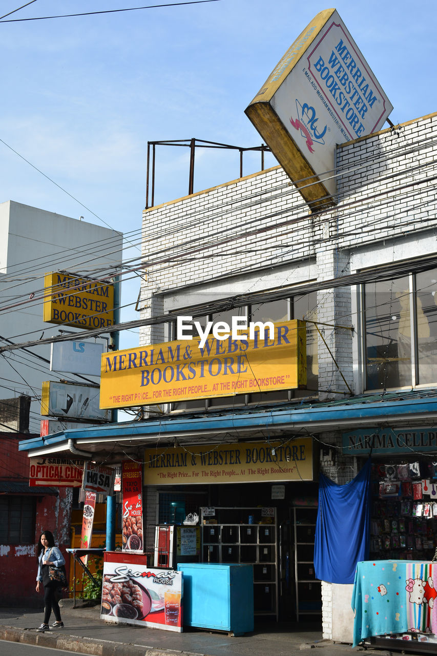 INFORMATION SIGN ON BUILDING AGAINST SKY