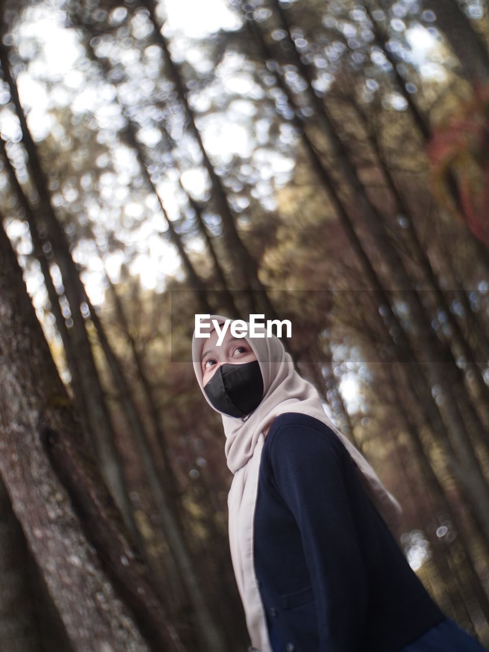 low angle view of man standing in forest