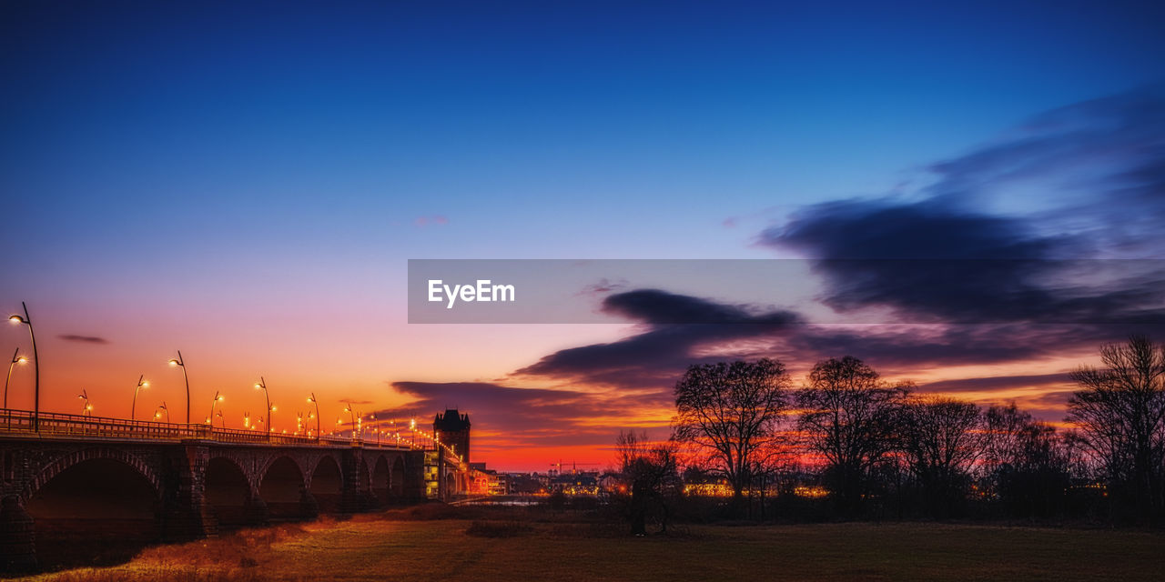 Silhouette bridge against sky during sunset