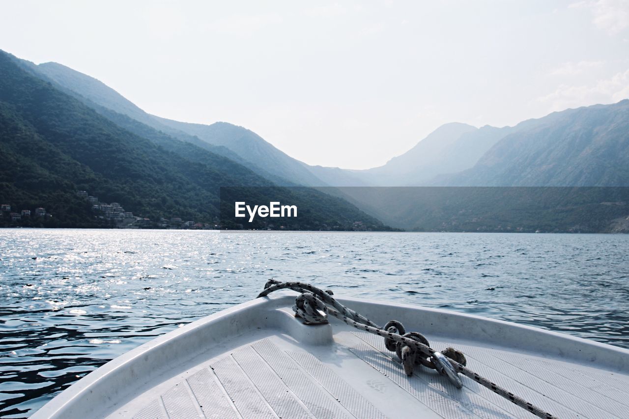 Scenic view of lake by mountains against sky