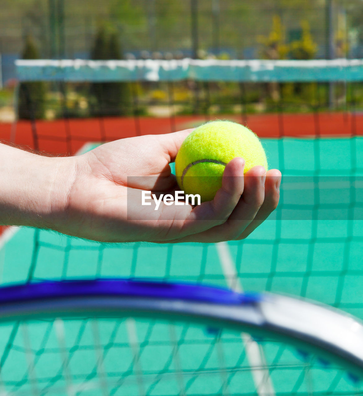 Cropped hand of person holding tennis ball