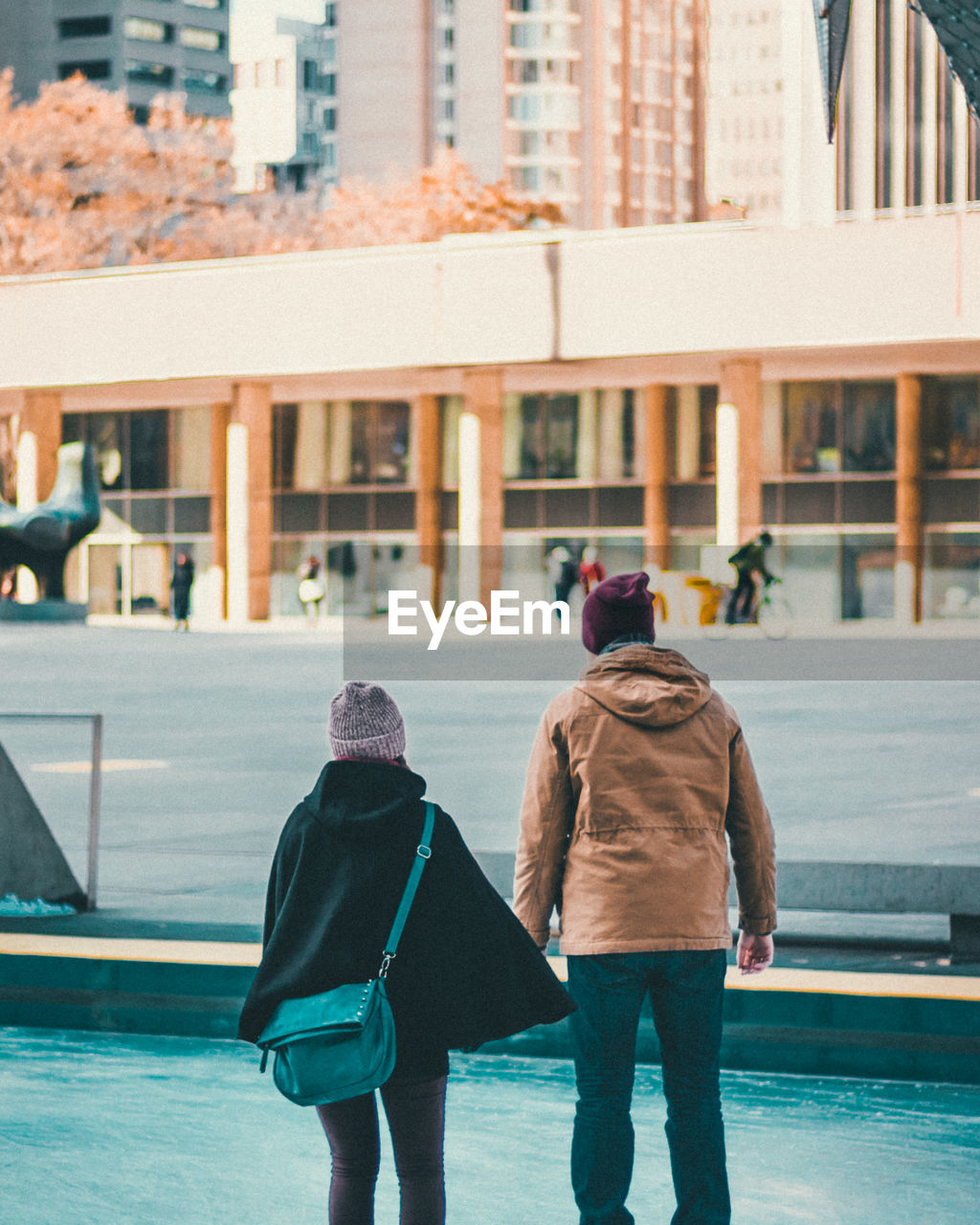 REAR VIEW OF PEOPLE WALKING IN WINTER