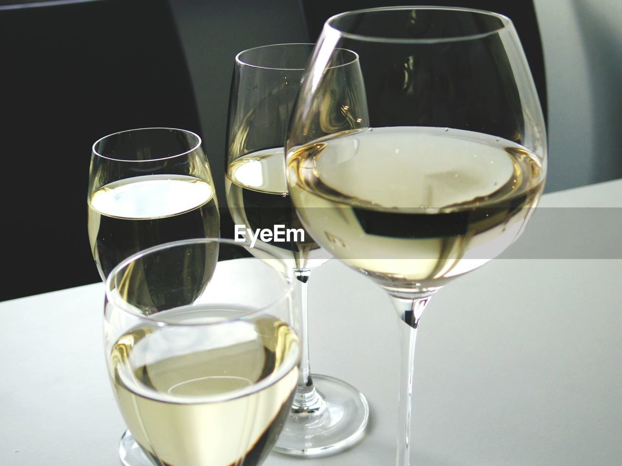High angle view of white wine in glasses on table