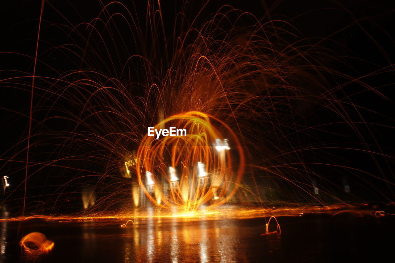Close-up of illuminated wirewool photography against sky at night
