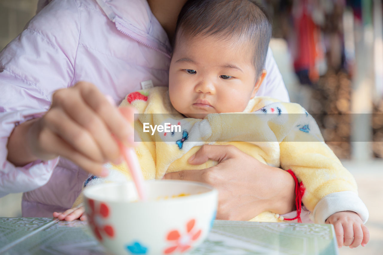 Portrait of cute baby girl holding ice cream