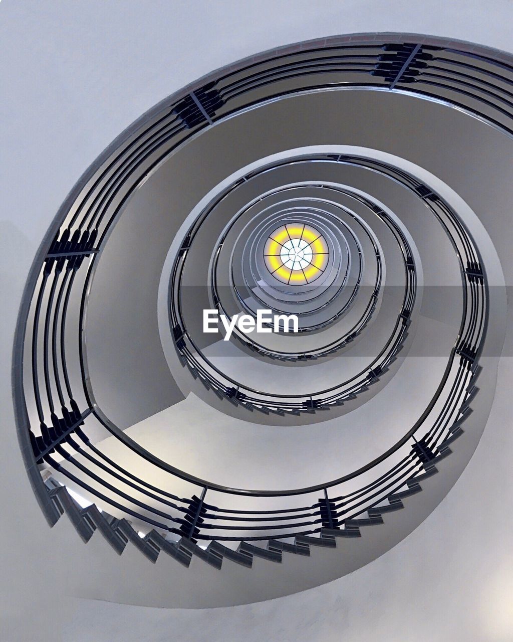 LOW ANGLE VIEW OF SPIRAL STAIRS AGAINST SKY