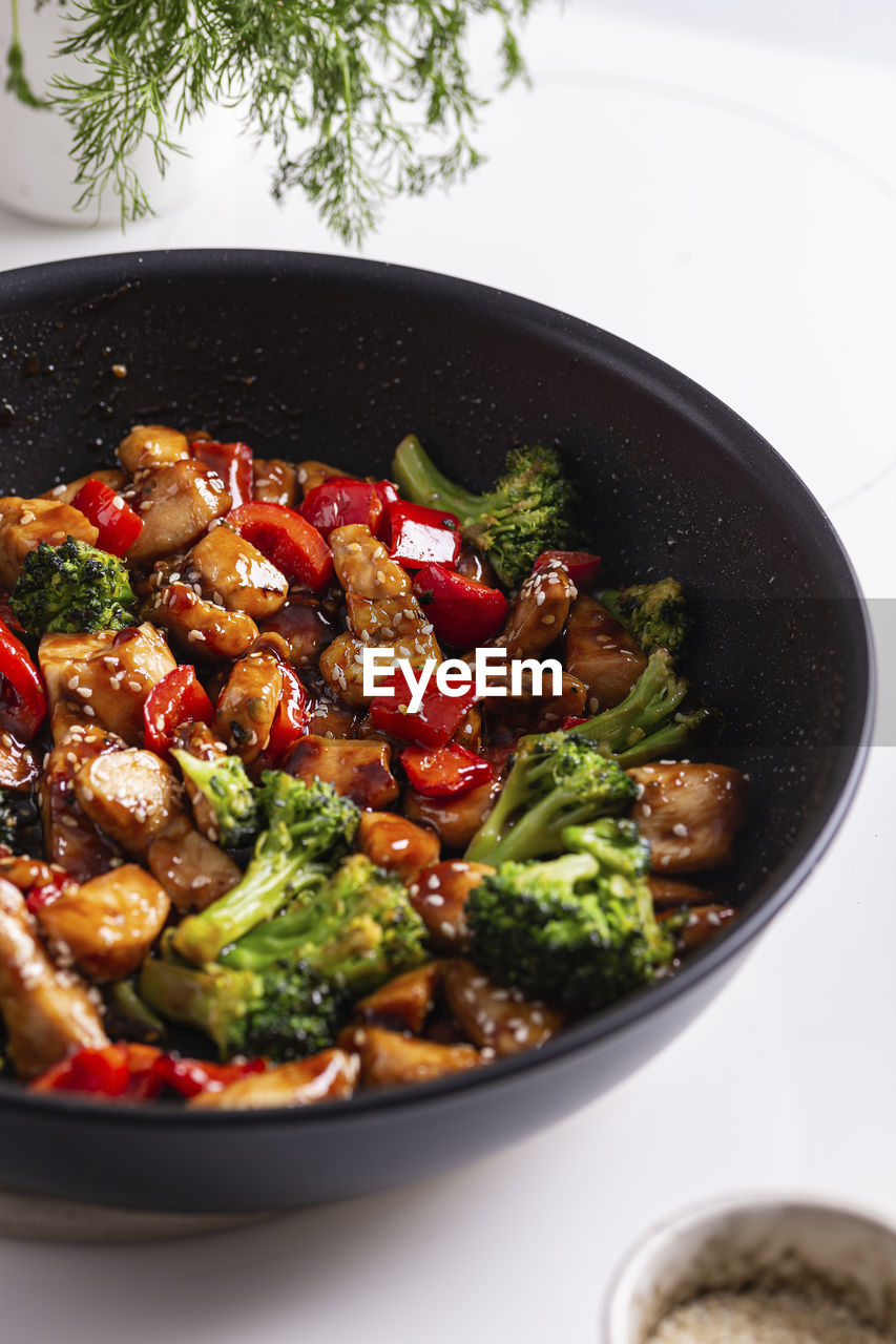 Teriyaki chicken with vegetables on a frying pan
