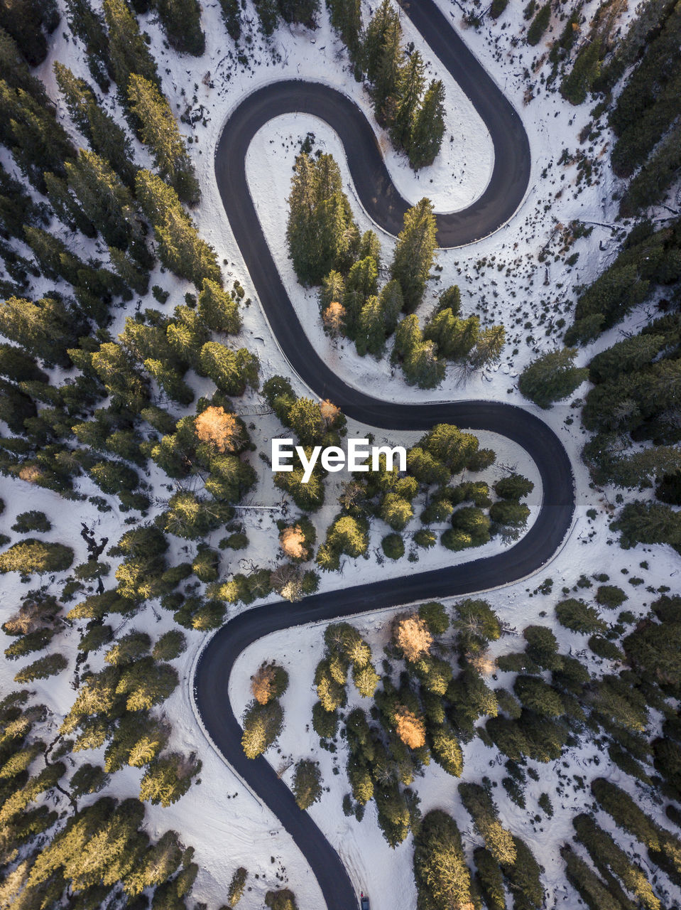 High angle view of winding road from above at sunrise. aerial view of snake road at italy,dolomities