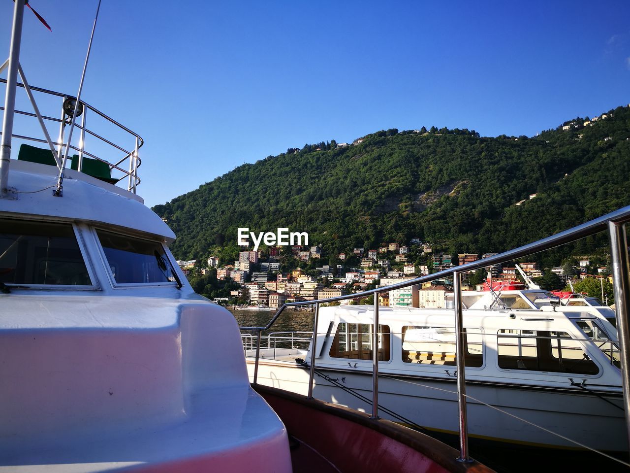 Boats on mountain against clear blue sky