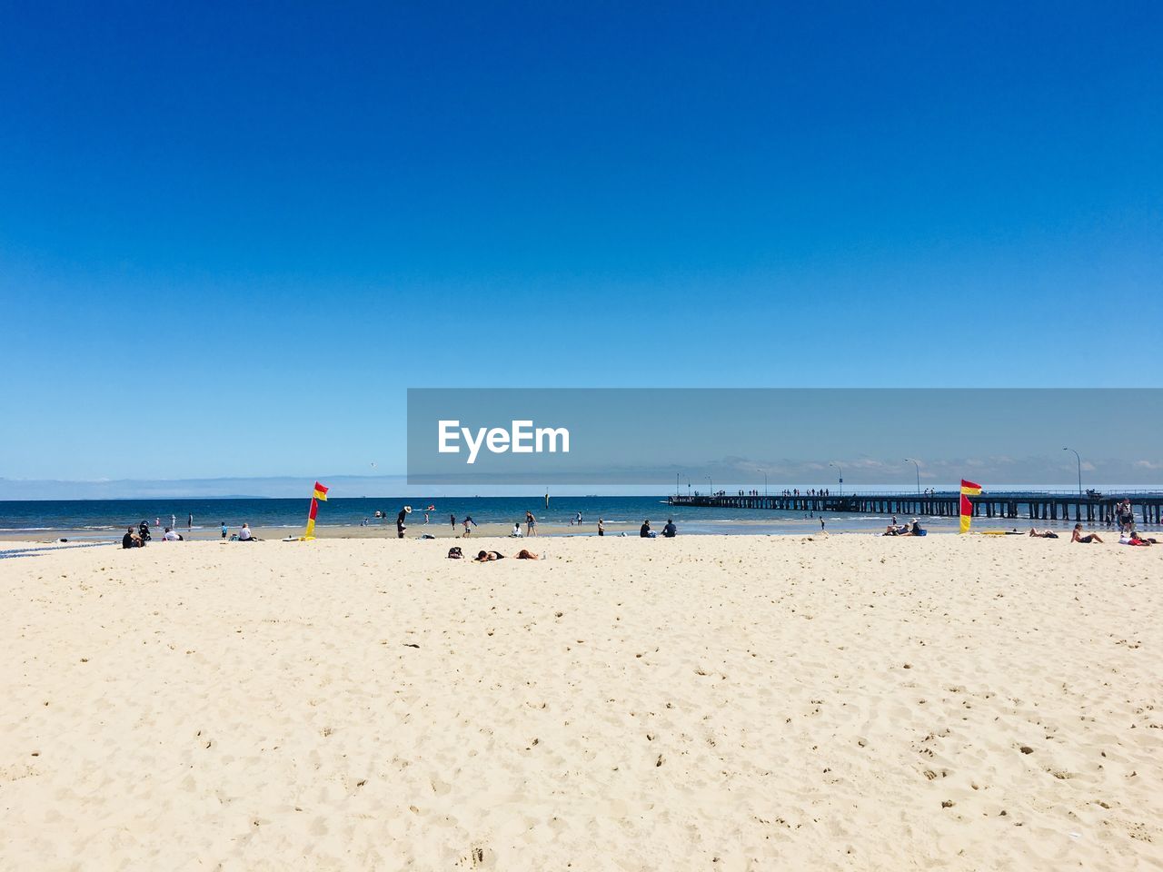 PANORAMIC VIEW OF BEACH AGAINST CLEAR BLUE SKY