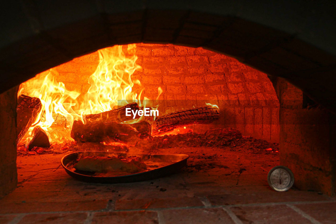 CLOSE-UP OF BURNING FIRE IN CONTAINER