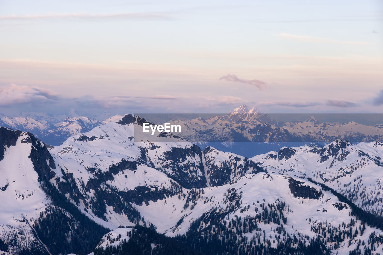 SCENIC VIEW OF SNOWCAPPED MOUNTAINS AGAINST SKY DURING WINTER