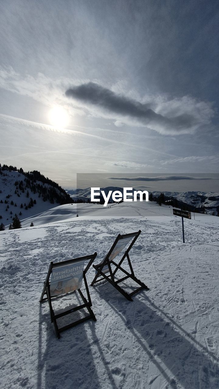 Scenic view of snow covered field against sky