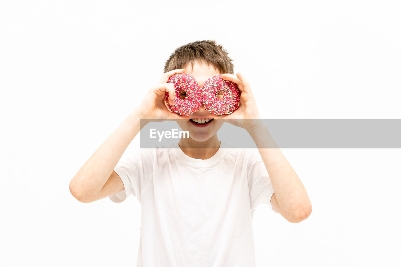Portrait of a boy with a donut on his face