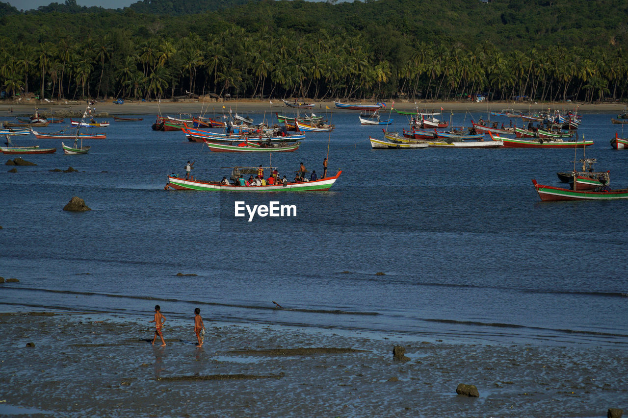 BOATS MOORED IN LAKE