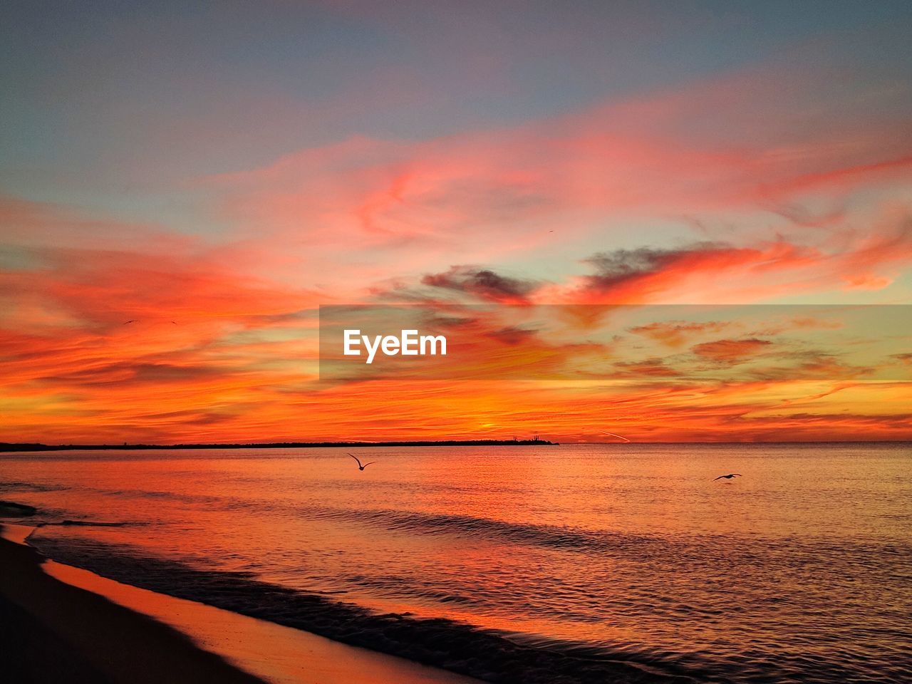 View of calm sea at sunset