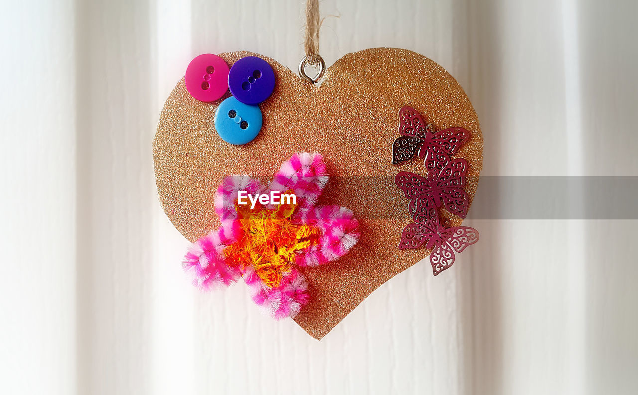 CLOSE-UP OF HEART SHAPE MADE OF PINK CAKE