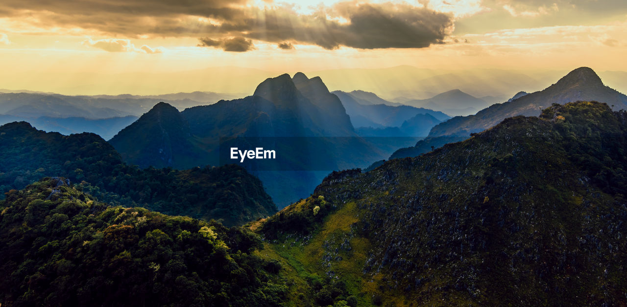 Panoramic beautiful scenic mountain range with blue sky, cloud and blast horizon sun