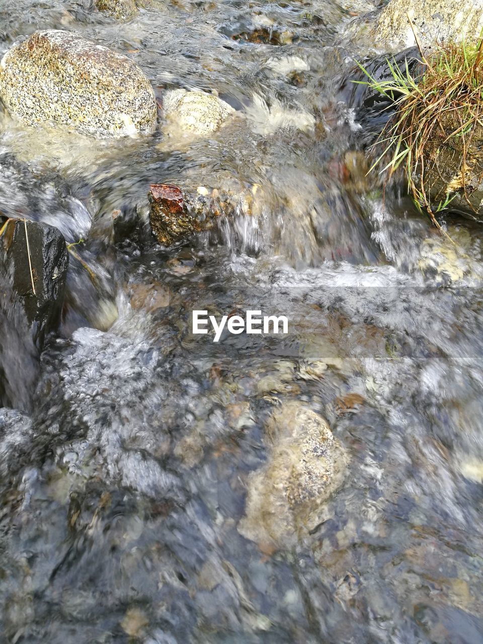 WATER FLOWING THROUGH ROCKS