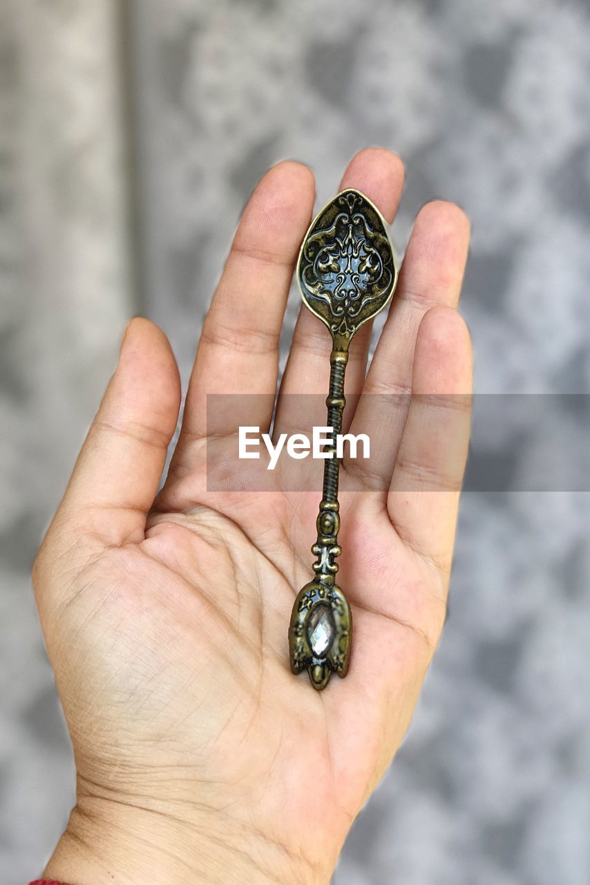 Close-up of hand holding spoon