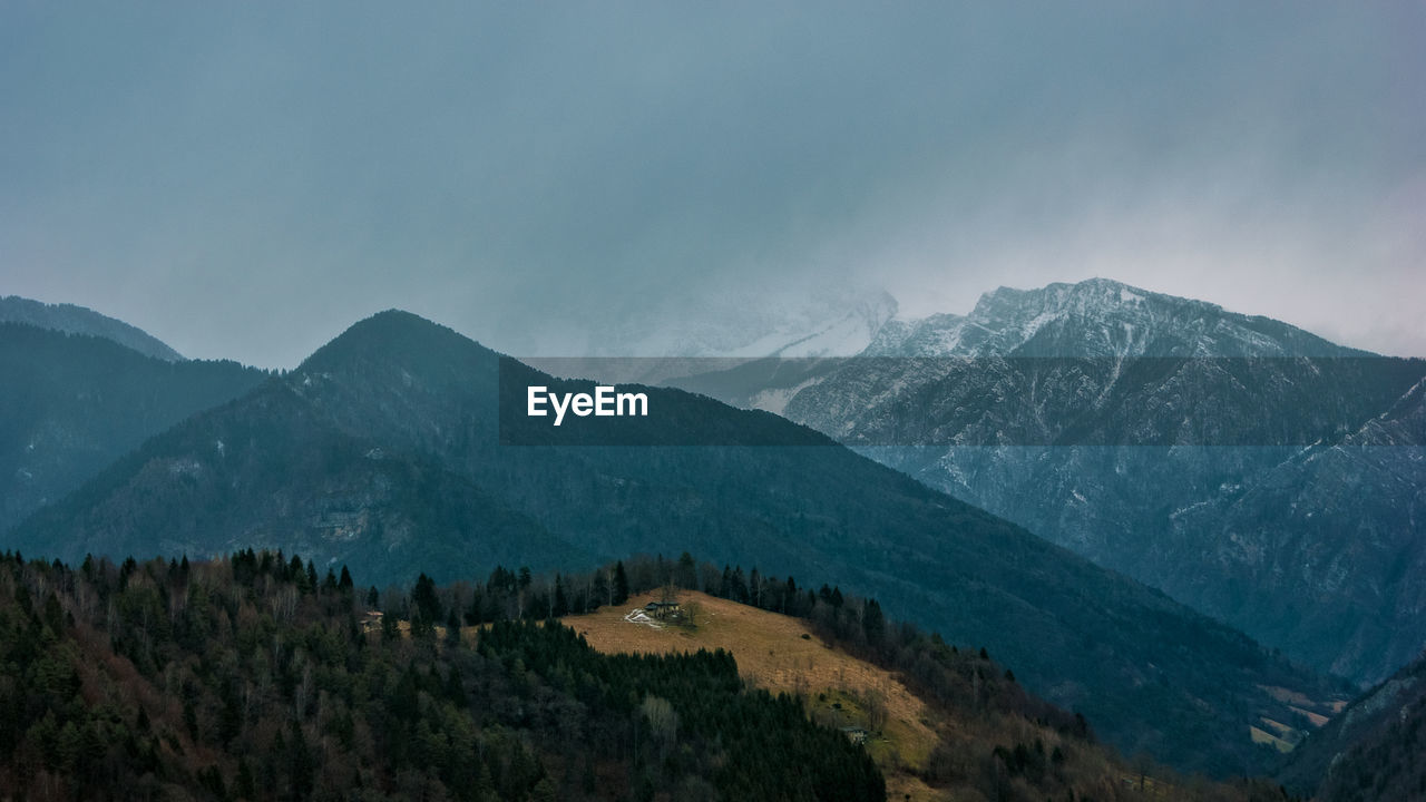 Scenic view of mountains against sky during winter