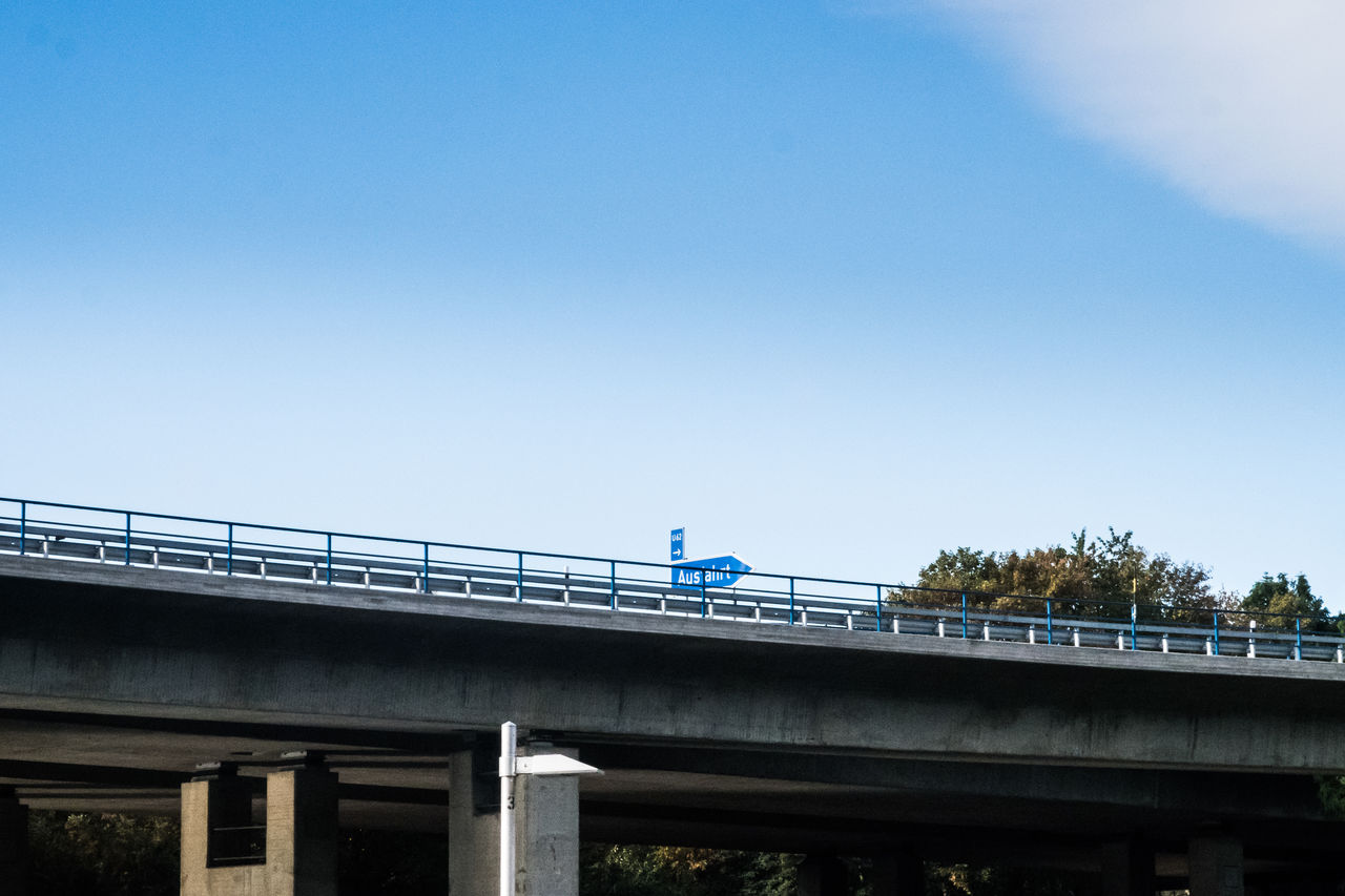 Low angle view of bridge against blue sky