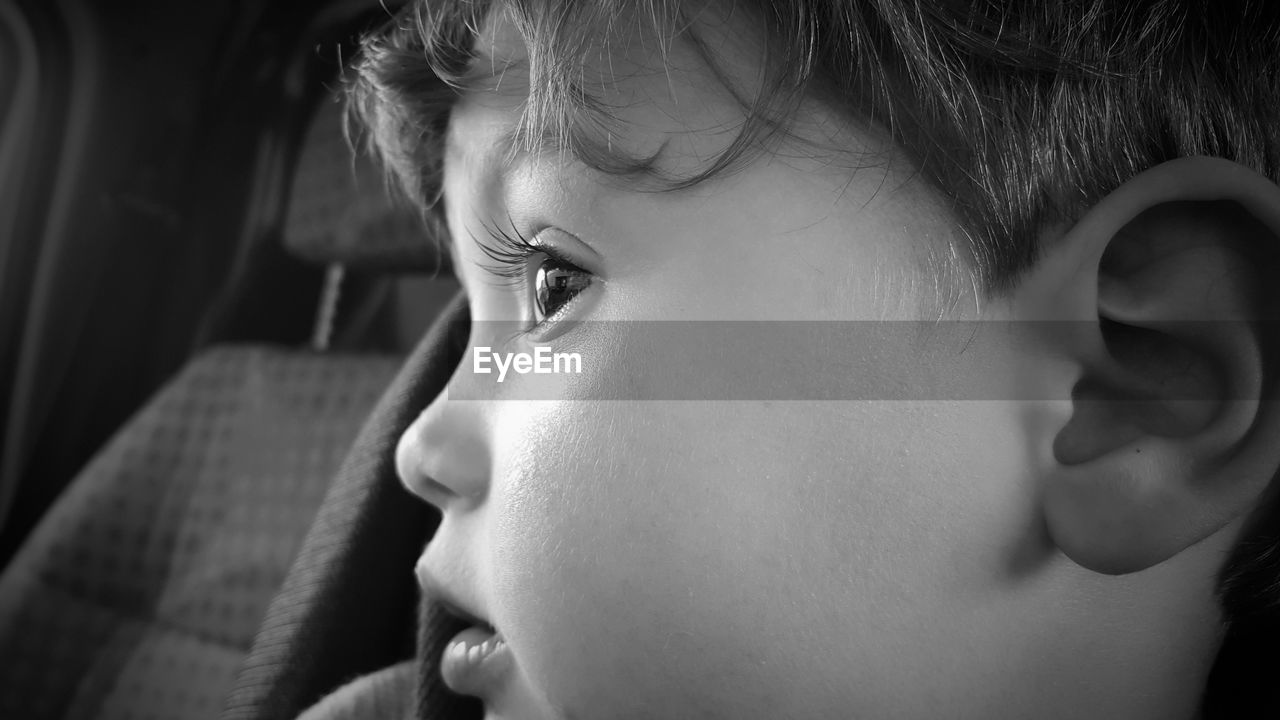 Close-up of young boy in car