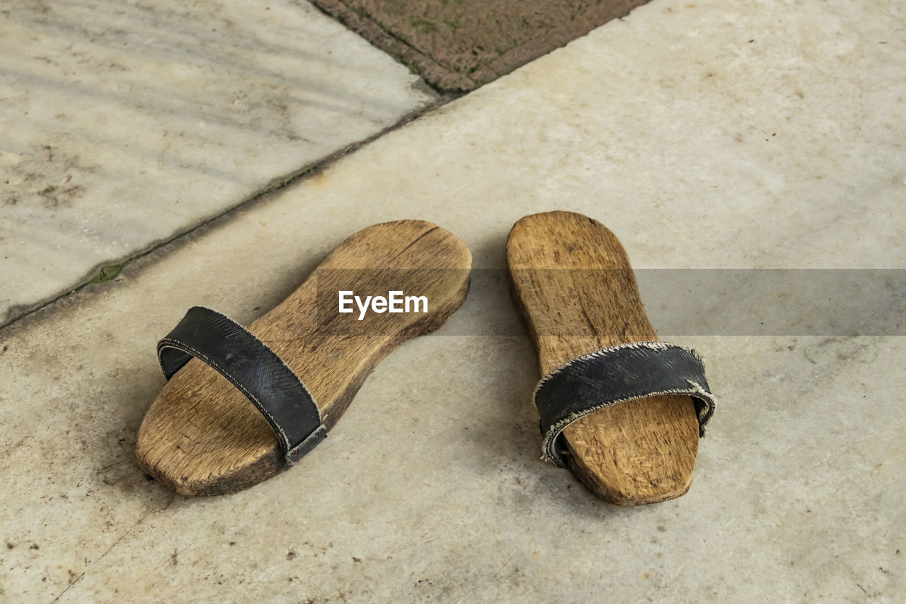 A pair of clogs for turkish bath.shoes with a thick wooden sole.