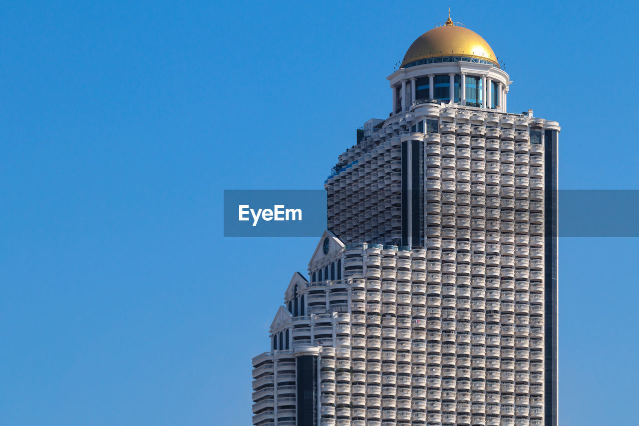 Top part of state tower, a skyscraper located on silom road, bang rak district, bangkok, thailand 