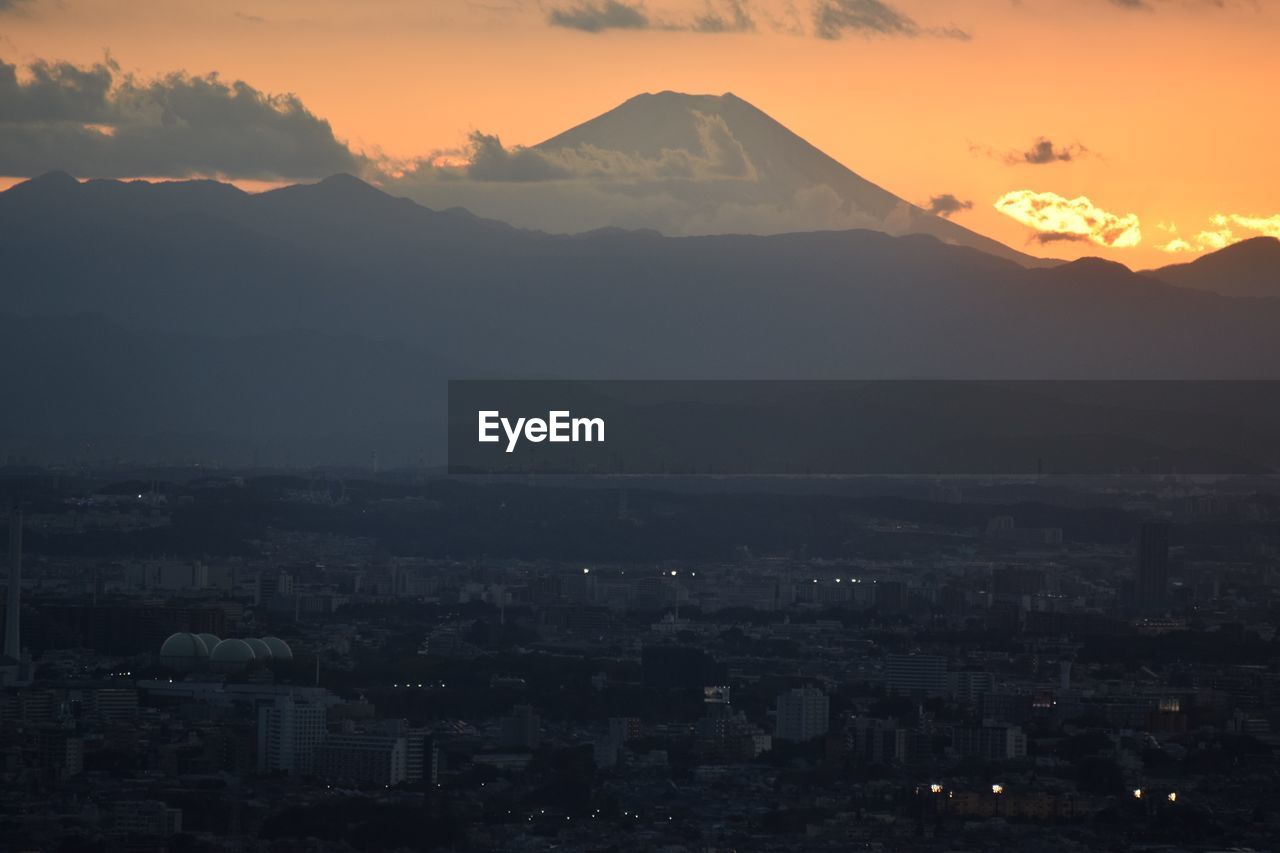 Aerial view of townscape against sky at sunset