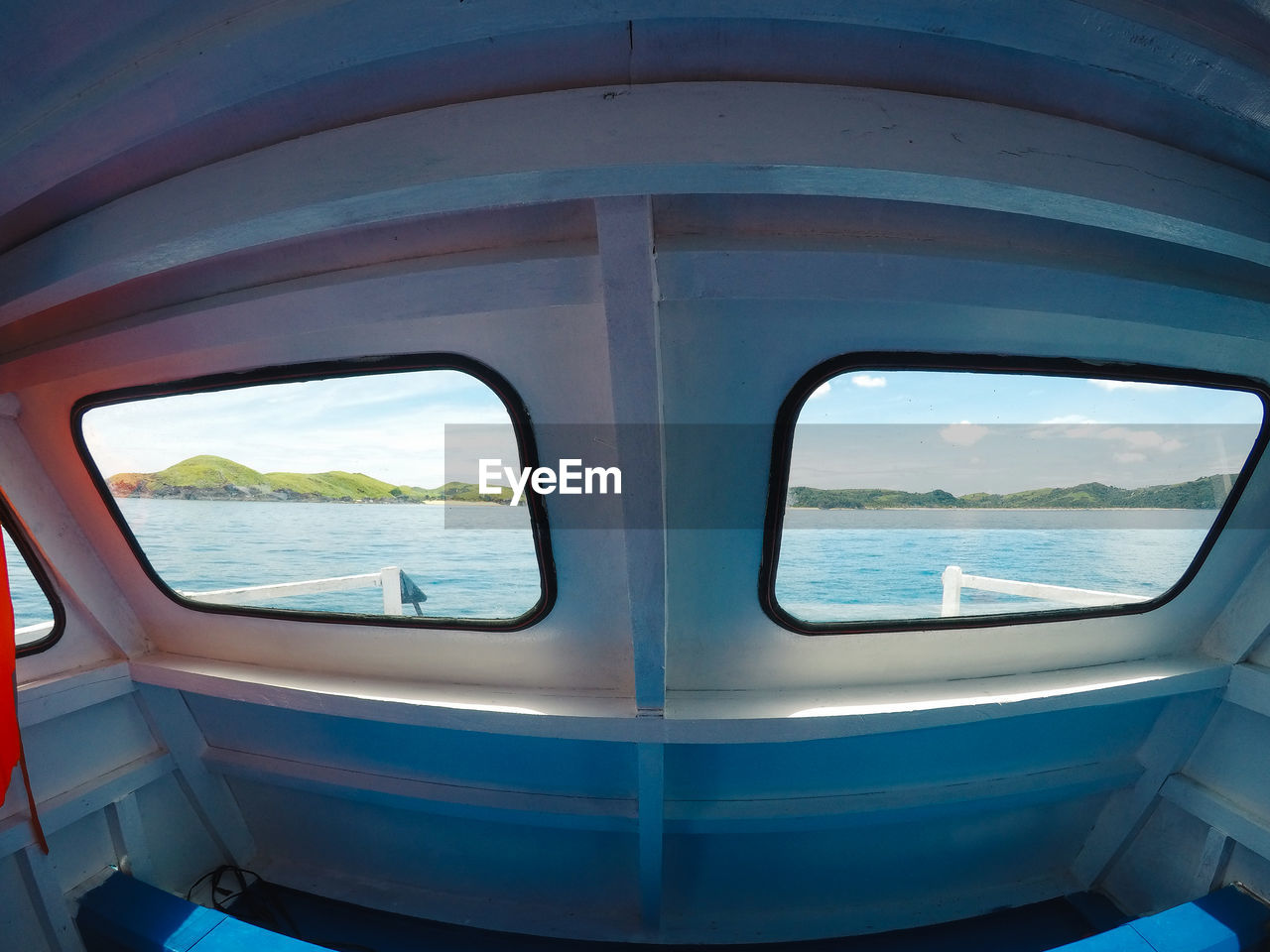 CLOSE-UP OF TRAIN WINDOW AT SEA