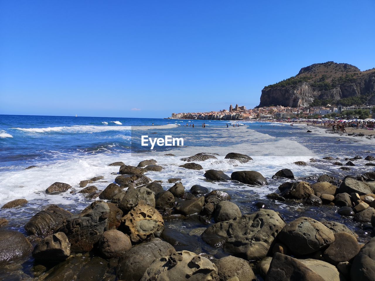 Scenic view of sea against clear blue sky