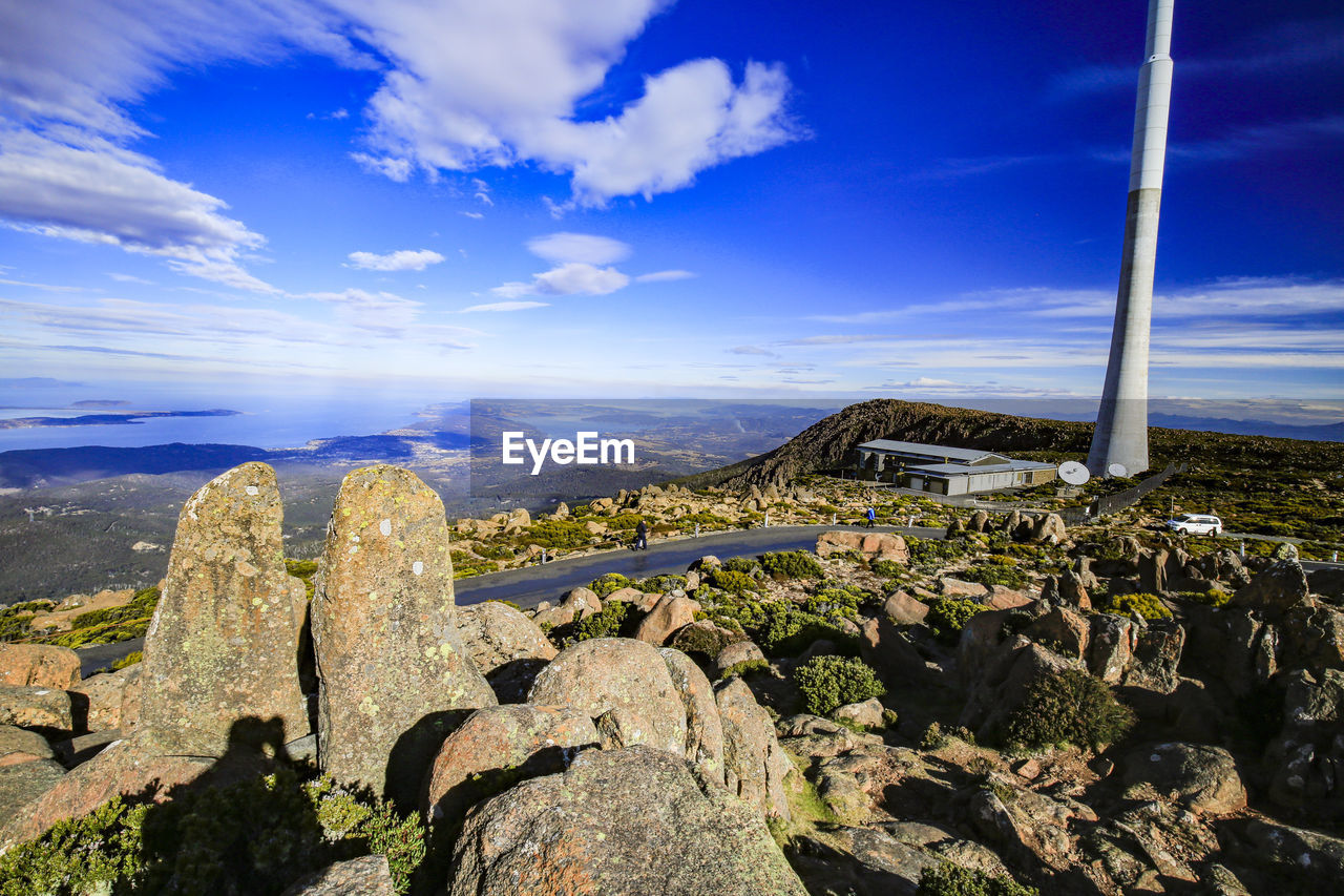 Panoramic view of rocks and mountains against blue sky