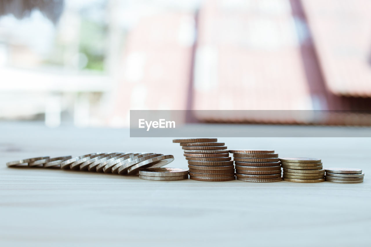 CLOSE-UP OF COINS ON TABLE OF STACK OF OBJECTS