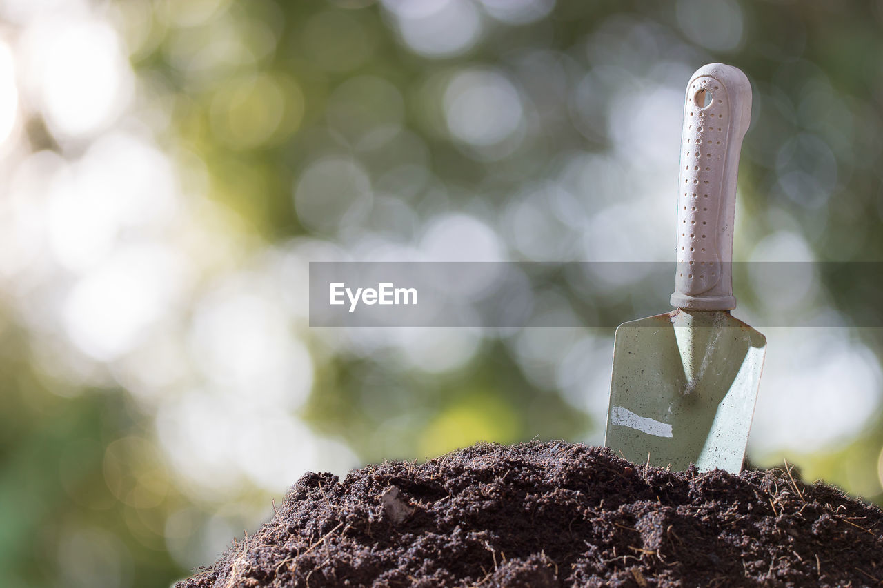 Close-up of shovel on dirt