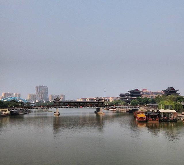 VIEW OF RIVER WITH BUILDINGS IN BACKGROUND