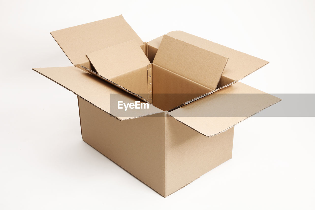 Close-up of cardboard boxes over white background