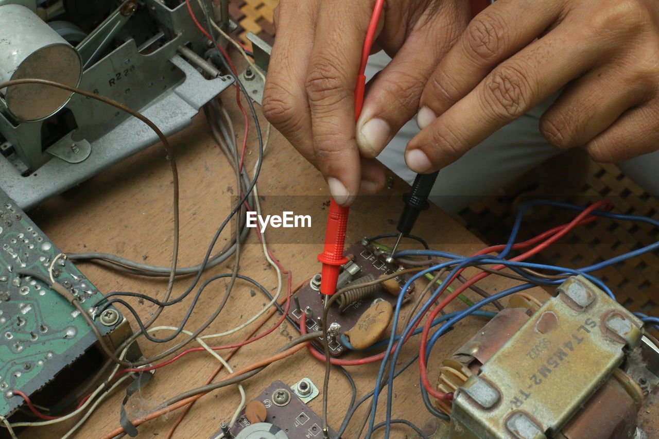 Cropped hands of man working in workshop