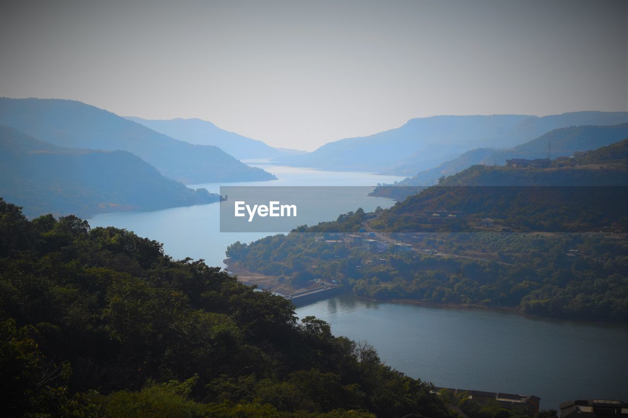 Scenic view of lake and mountains against sky