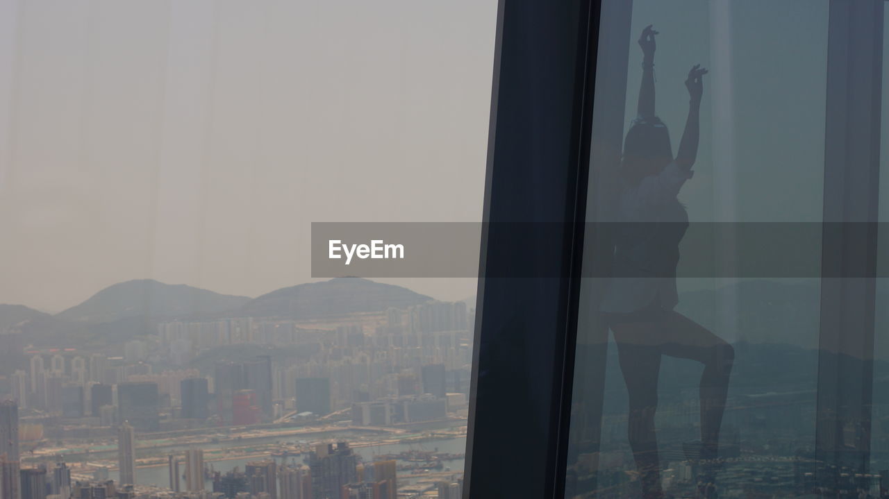 VIEW OF CITY THROUGH GLASS WINDOW