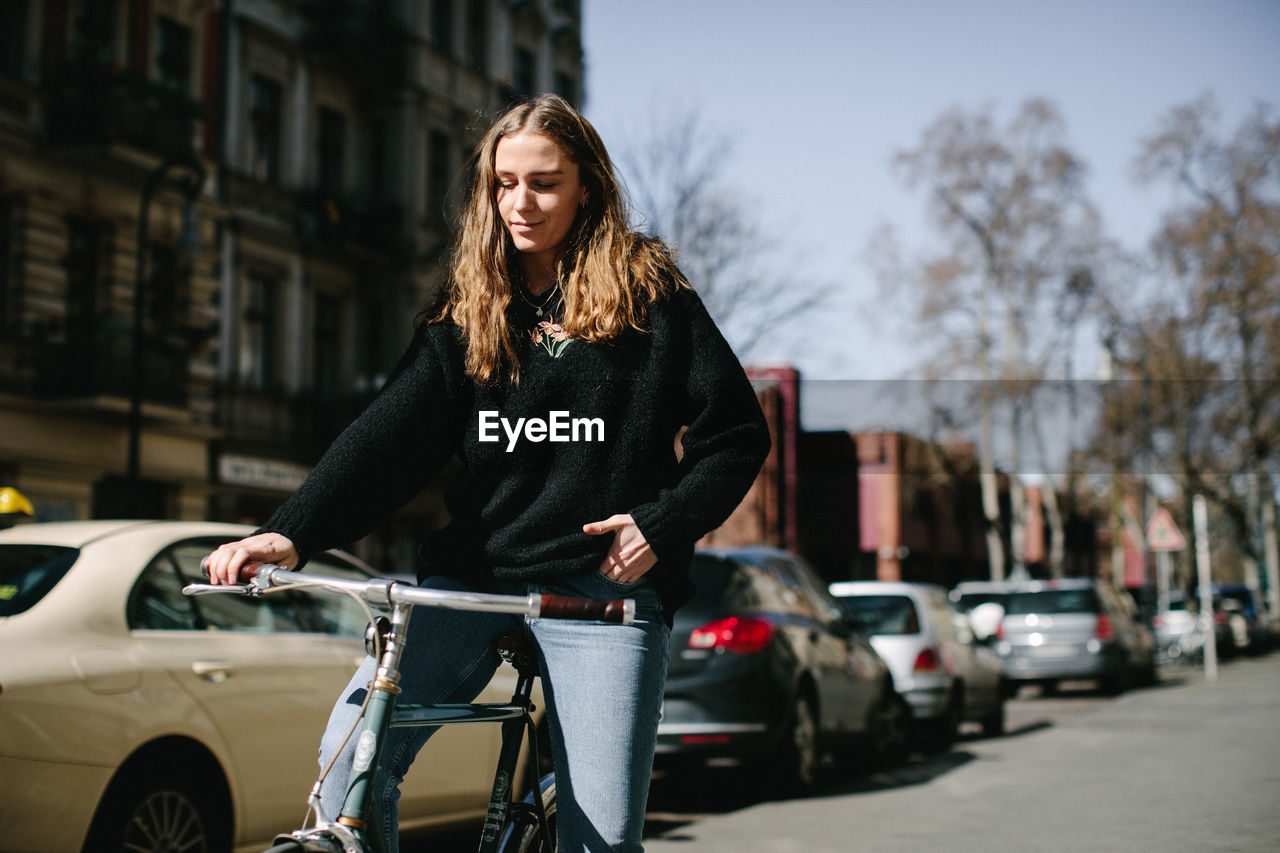 WOMAN RIDING BICYCLE ON STREET