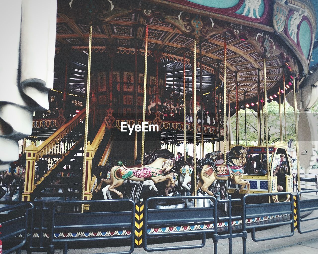 PEOPLE IN AMUSEMENT PARK RIDE