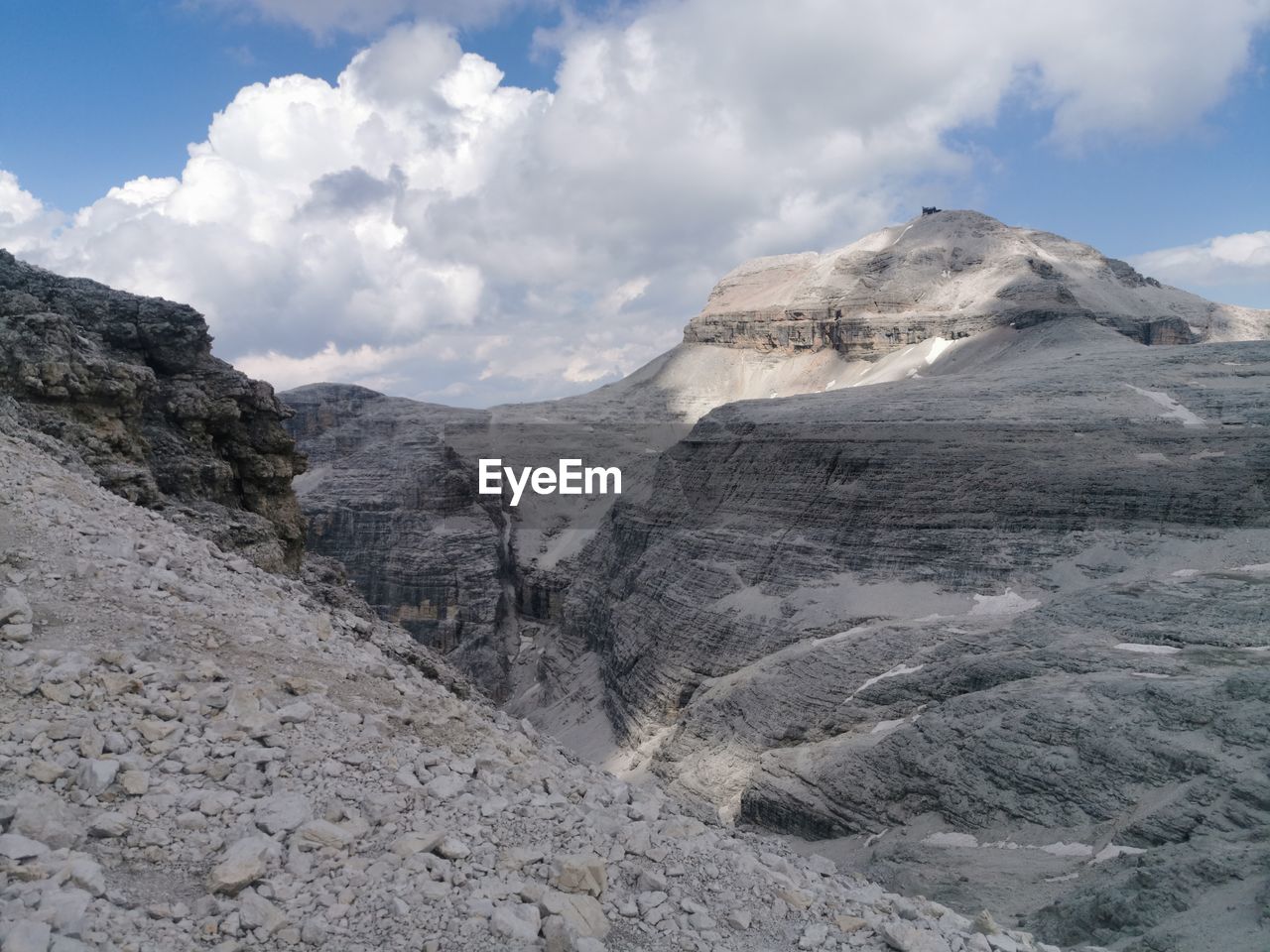 mountain, cloud, environment, landscape, sky, scenics - nature, beauty in nature, nature, ridge, mountain range, moraine, land, rock, no people, non-urban scene, travel, mountain pass, travel destinations, outdoors, wilderness, day, geology, plateau, adventure, snow, extreme terrain, tranquility, tourism, summit, activity, tranquil scene, volcano, mountain peak, physical geography, blue, cold temperature, outdoor pursuit