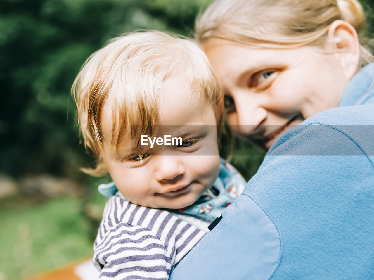 Portrait of cute mother with son outdoors