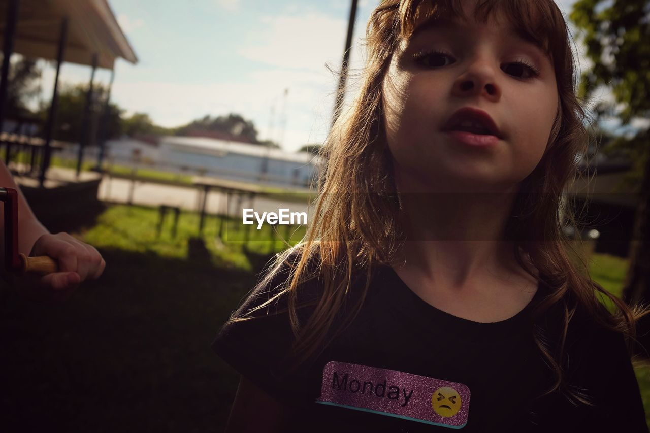 Close-up portrait of girl standing outdoors