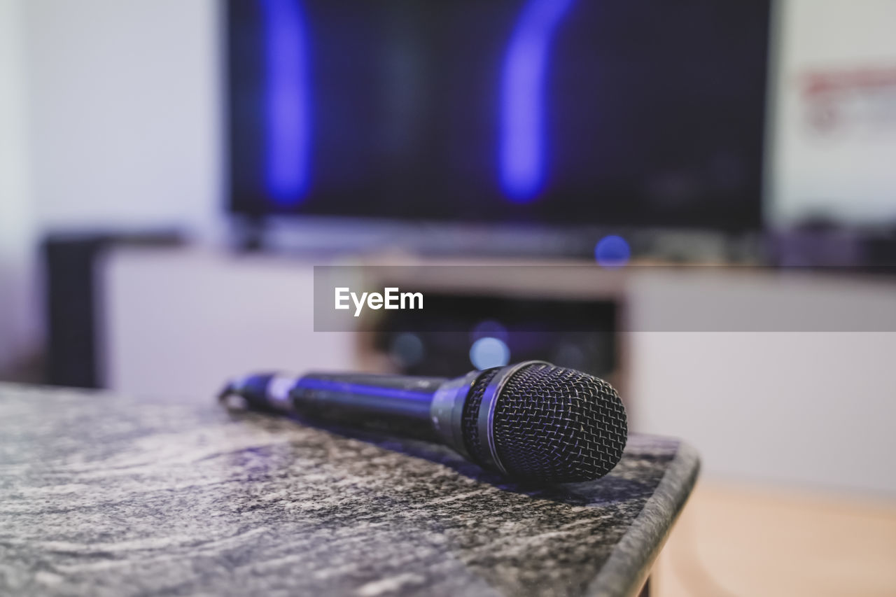 technology, blue, microphone, music, input device, table, indoors, audio equipment, arts culture and entertainment, close-up, no people, sound recording equipment, communication, studio, recording studio, room, equipment, focus on foreground, furniture, gadget, selective focus