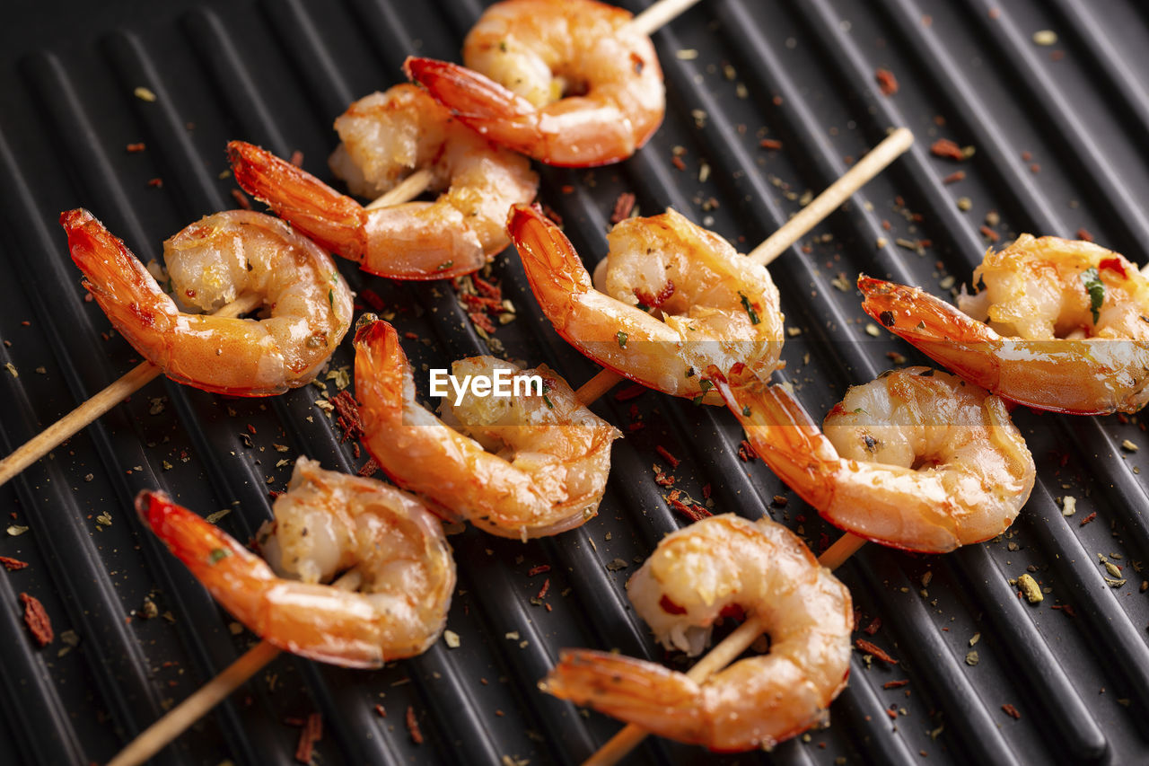 shrimp, food, food and drink, barbecue, barbecue grill, freshness, grilled, seafood, dish, no people, animal, healthy eating, meat, heat, grilling, cuisine, kitchen utensil, snack, close-up, wellbeing, meal, skewer, crustacean, grate, prawn, fruit, high angle view, grid
