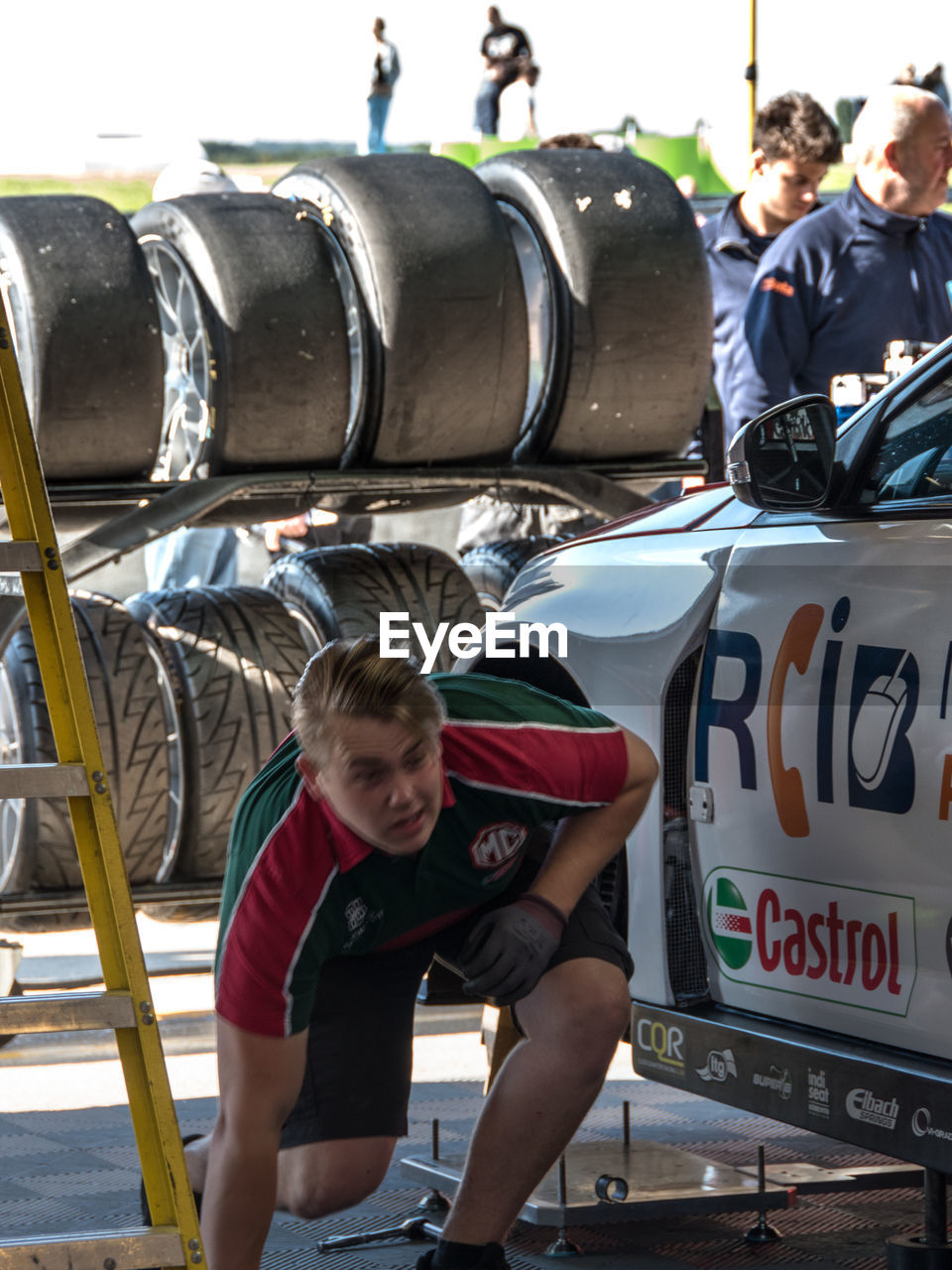 PORTRAIT OF BOY ON CAR