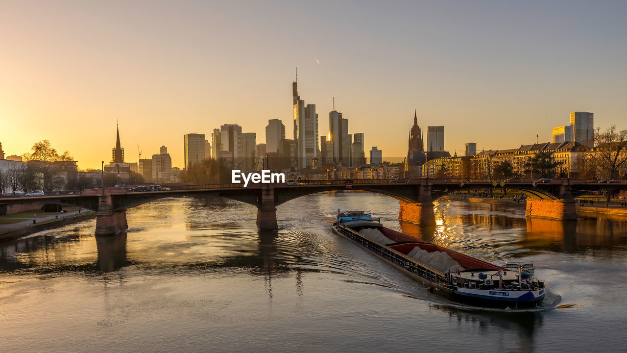 SCENIC VIEW OF RIVER BY BUILDINGS AGAINST SKY